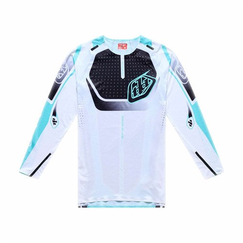 The TLD 26.1 Sprint Ultra Jersey / Proton White is a long-sleeved athletic jersey with black and turquoise graphics, crafted from Ultra Knit fabric, and featuring Troy Lee Designs logos on the chest and sleeves, shown on a white background.