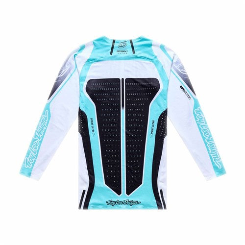 The TLD 26.1 Sprint Ultra Jersey in Proton White is a long-sleeve cycling or motocross jersey with aqua blue and black accents, moisture wicking fabric, and "Troy Lee Designs" branding on the sleeves and lower back.