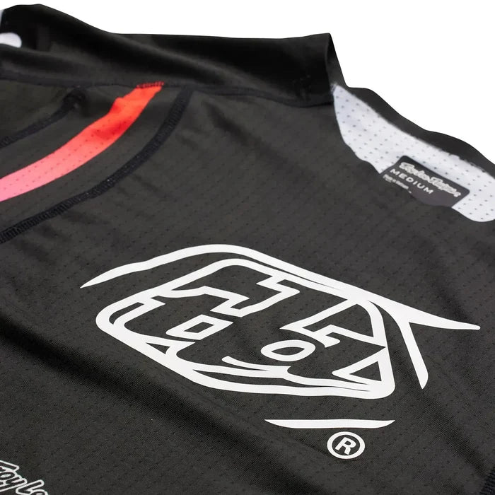 A TLD Sprint Ultra Jersey Pinned Black with a red logo on it.