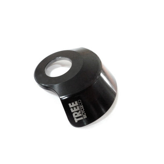 The Tree Bicycle Co DS Hub Guard is a black metal bike part featuring a circular opening and "TREE BICYCLE CO" text on the side. This Chro-Mo hub guard enhances durability, fitting most hubs for seamless integration with your ride.