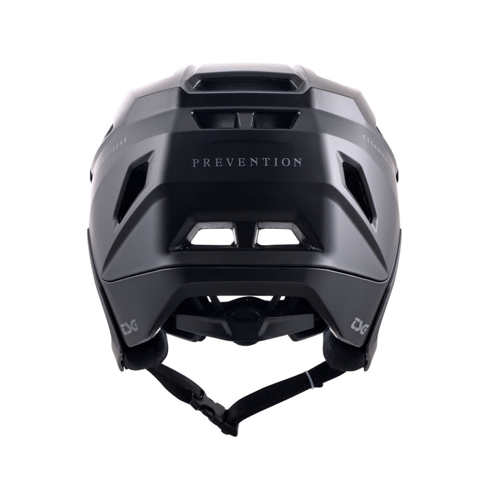 The TSG Prevention Helmet Satin Black, shown from the back, features ventilation, an adjustable strap, and "PREVENTION" printed on the rear—ideal for BMX riders wanting comfort and protection.