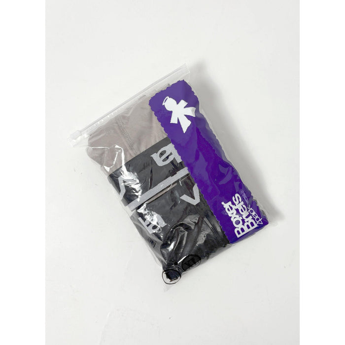 A clear plastic bag with a purple stripe contains V1da Boxer Briefs (2 Pack) in black and gray, featuring visible white lettering and an updated mid-length design.