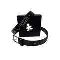 The V1da Studded Leather Belt, crafted from genuine leather with silver studs and star accents, is showcased in front of a black box adorned with a white angel silhouette logo.
