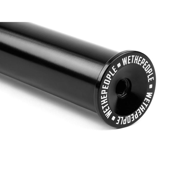 A close-up of a black cylindrical metal peg with "WETHEPEOPLE" in white on the end cap, attached to a BMX fork—showcasing the quality details of Wethepeople Flash Forks.