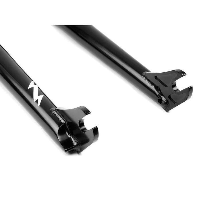 A close-up of two black Wethepeople Flash Forks BMX dropouts with a white zigzag logo on one leg, set against a white background—highlighting the fork’s signature style.
