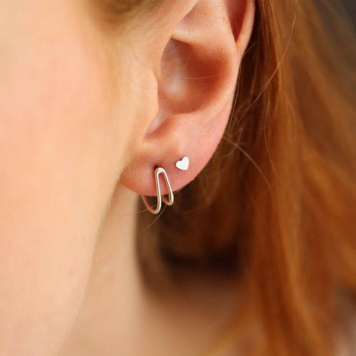 model wearing 14k gold fill wishbone style stud earrings