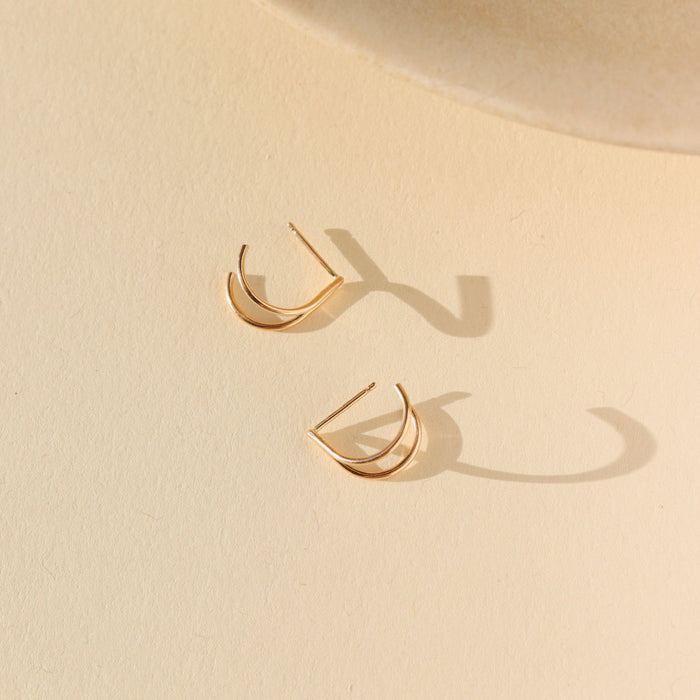 14k gold fill stud earrings on a light dish